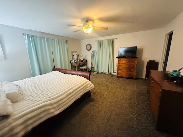 bedroom featuring dark carpet and ceiling fan