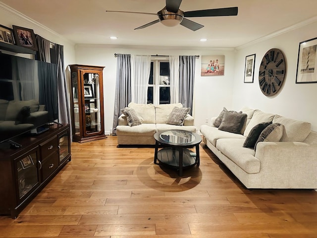 living room with ornamental molding, recessed lighting, light wood-style floors, and a ceiling fan