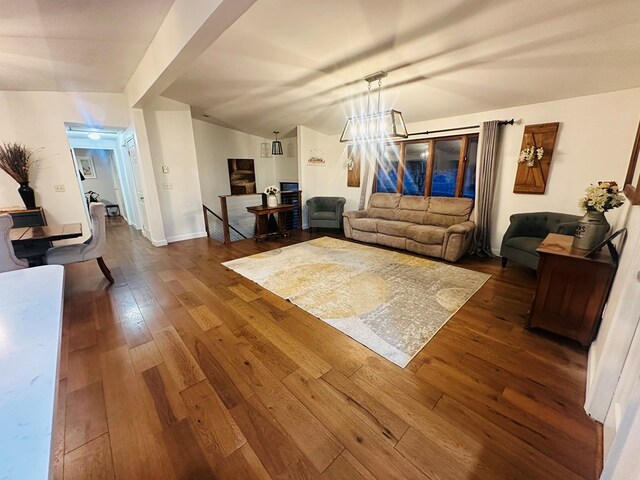 dining room with sink, vaulted ceiling, and hardwood / wood-style flooring