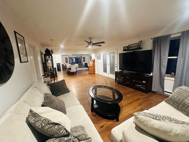 living area with ceiling fan and wood finished floors