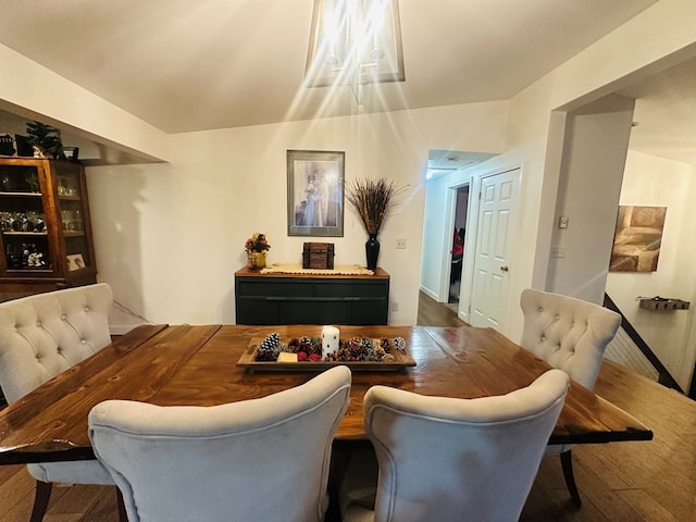 dining space with dark wood-style flooring