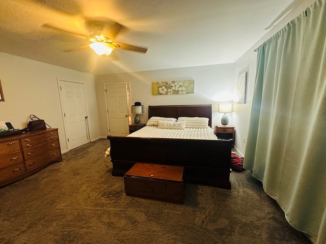 bedroom with ceiling fan and dark carpet