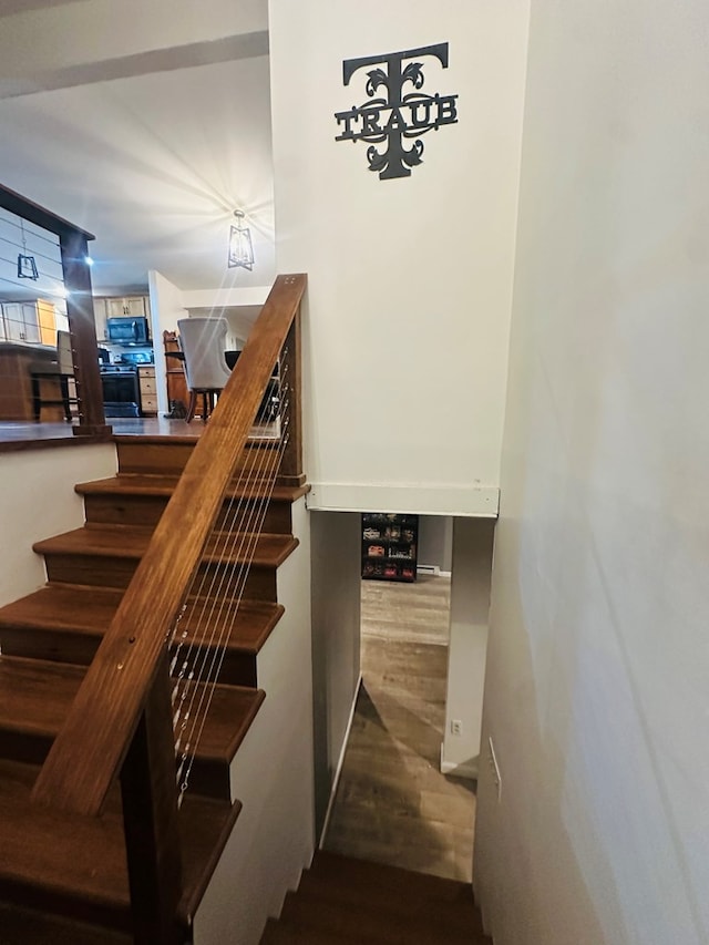 stairway with wood finished floors