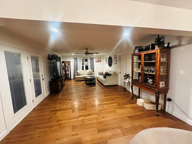 interior space featuring wood finished floors, a ceiling fan, and recessed lighting