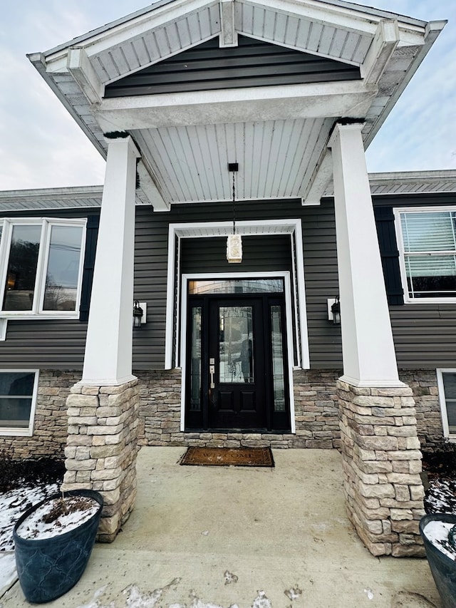 entrance to property featuring stone siding