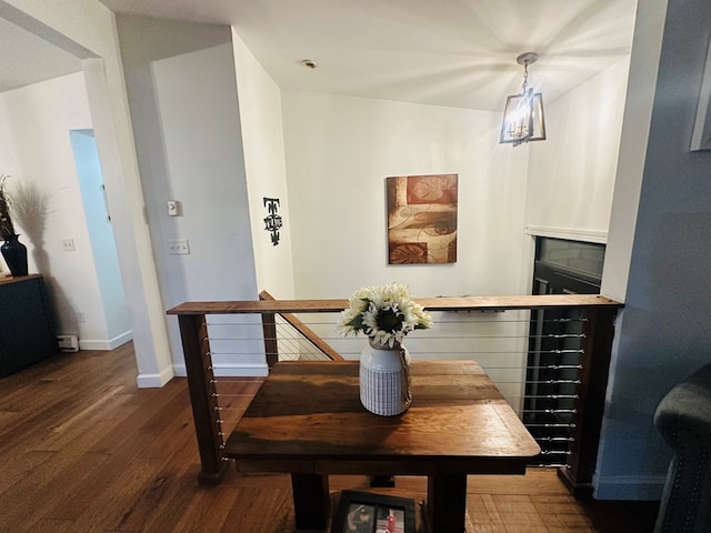 dining area featuring dark wood-style floors and baseboards