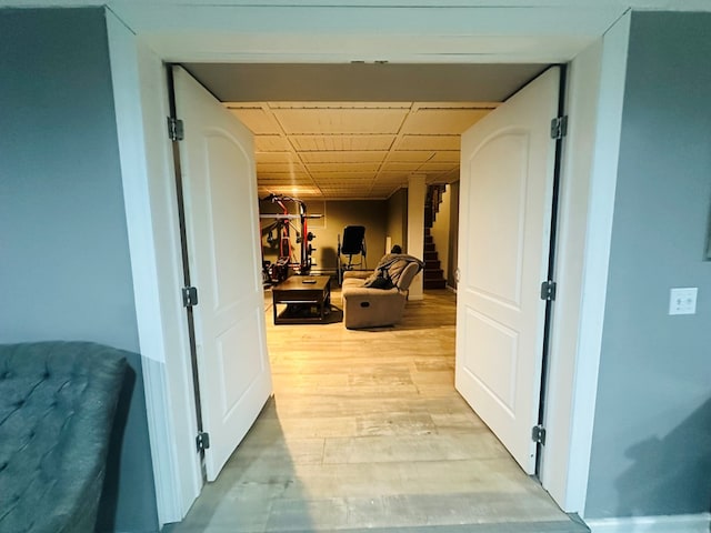 hallway with light wood-style floors and stairs