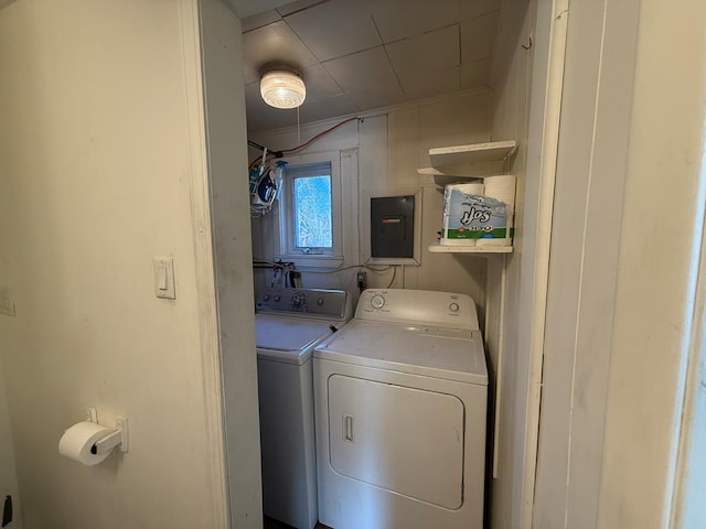 laundry area featuring electric panel, separate washer and dryer, and laundry area