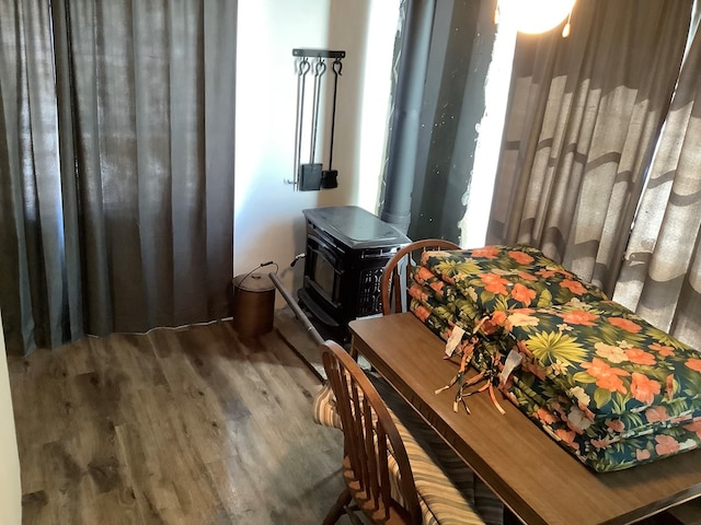 interior space featuring a wood stove and hardwood / wood-style flooring