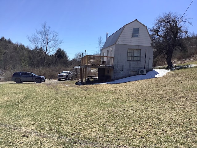 view of property exterior featuring a yard and a deck