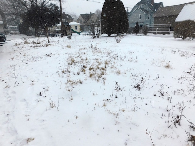 snowy yard with fence