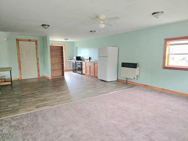 129 Liberty Corners Rd, Towanda, PA 18848 - unfurnished living room featuring carpet, a ceiling fan, wood finished floors, baseboards, and heating unit
