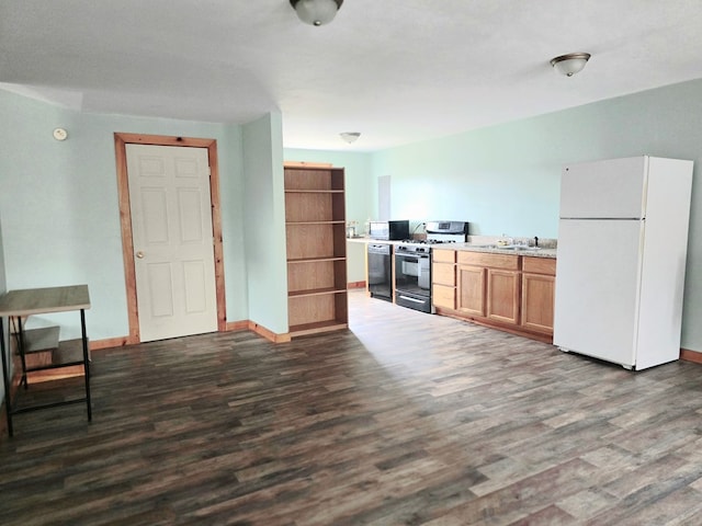 129 Liberty Corners Rd, Towanda, PA 18848 - kitchen with range with gas cooktop, black dishwasher, a sink, freestanding refrigerator, and dark wood finished floors