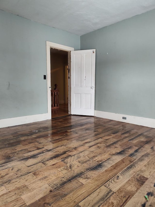 empty room featuring dark hardwood / wood-style flooring