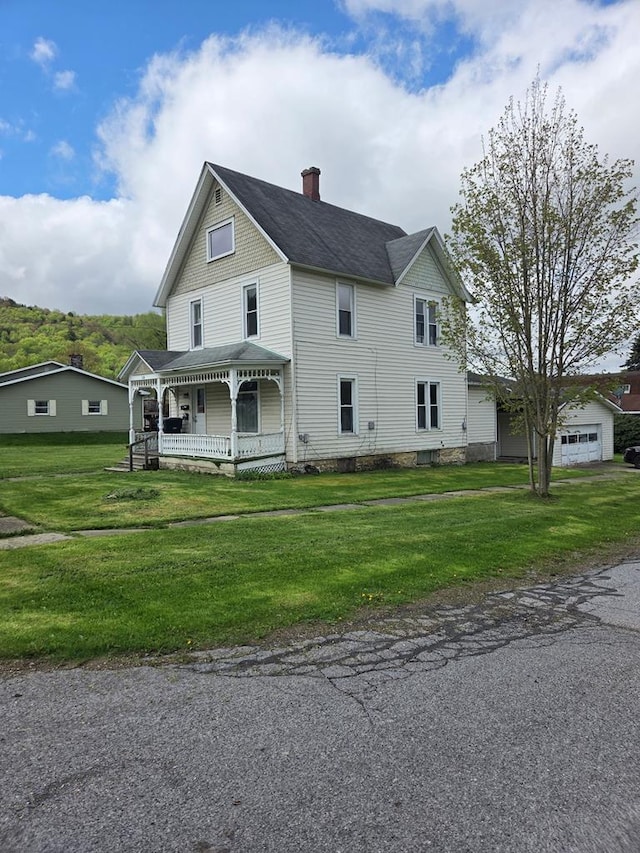 view of front facade with a chimney and covered porch