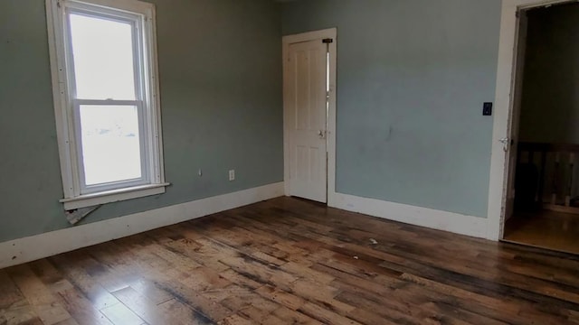 spare room with dark hardwood / wood-style flooring