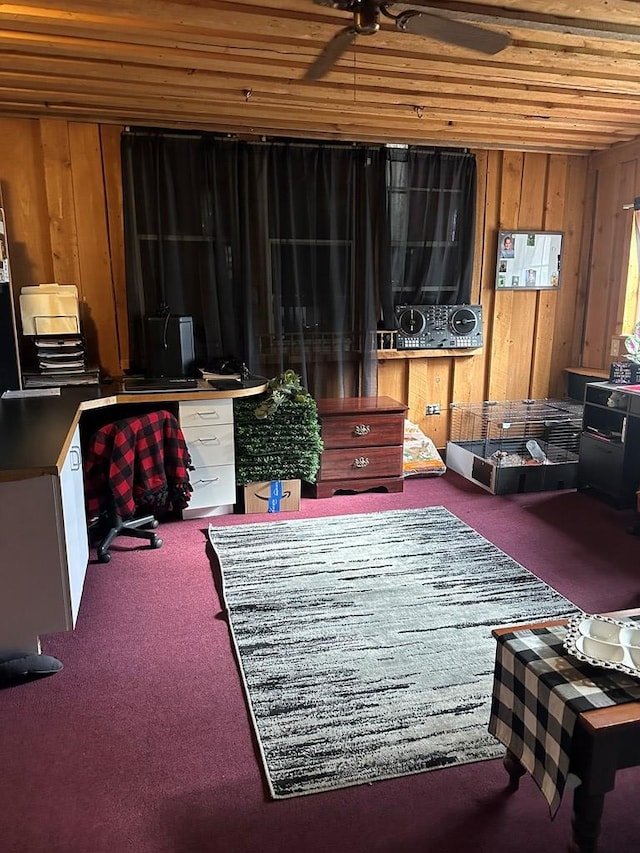 sitting room with carpet, ceiling fan, wood walls, and wood ceiling