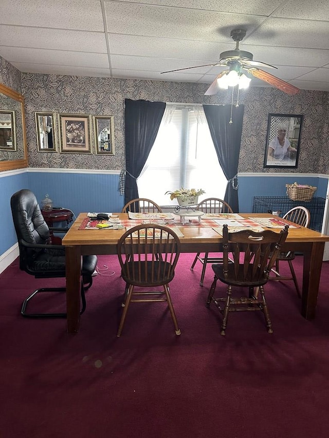 dining area with ceiling fan and a drop ceiling