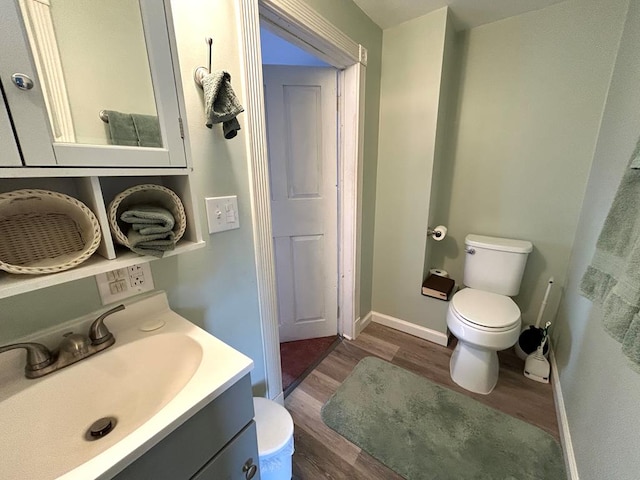 bathroom with vanity, hardwood / wood-style flooring, and toilet