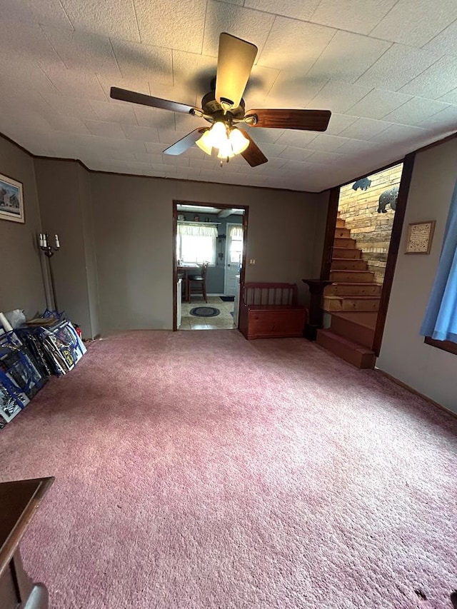 interior space featuring a textured ceiling, carpet floors, and ceiling fan