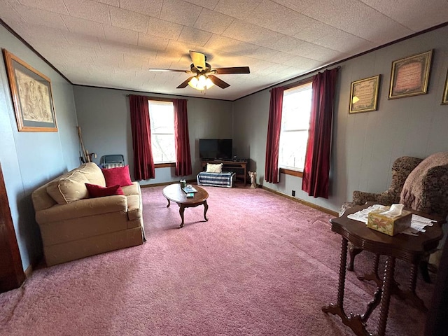 carpeted living room featuring crown molding, a wealth of natural light, and ceiling fan