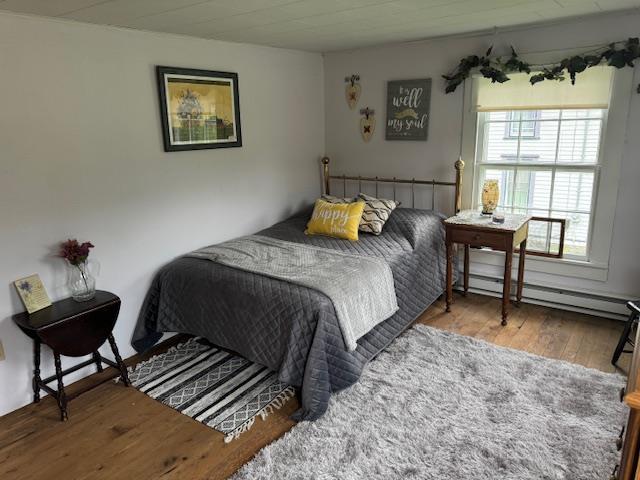 bedroom featuring light hardwood / wood-style flooring and a baseboard radiator