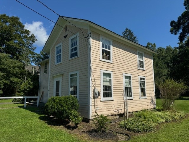 view of side of property with a yard