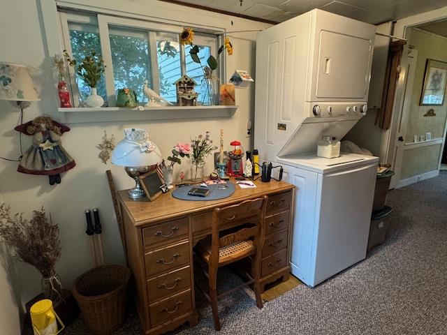 washroom with stacked washing maching and dryer and light carpet