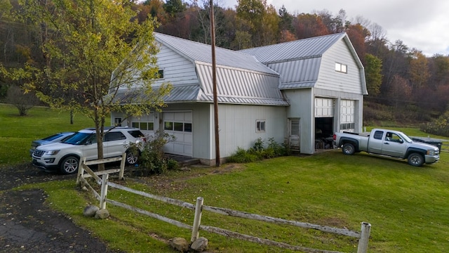 view of side of property with a lawn and an outdoor structure