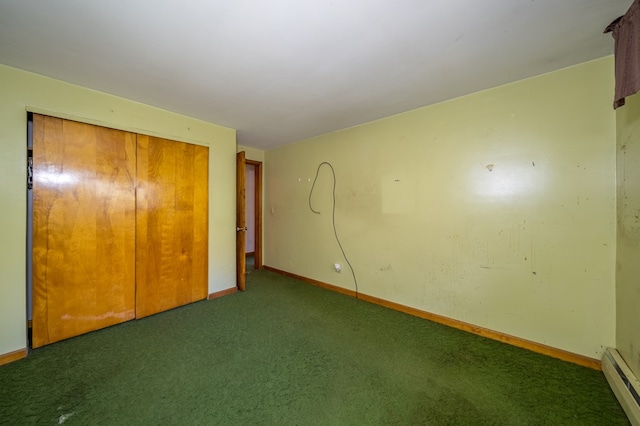 unfurnished bedroom with dark colored carpet, a baseboard radiator, and a closet