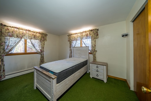 bedroom featuring dark carpet and baseboard heating