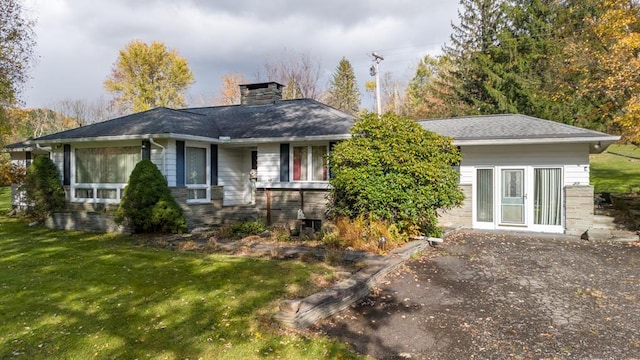 rear view of house featuring a yard