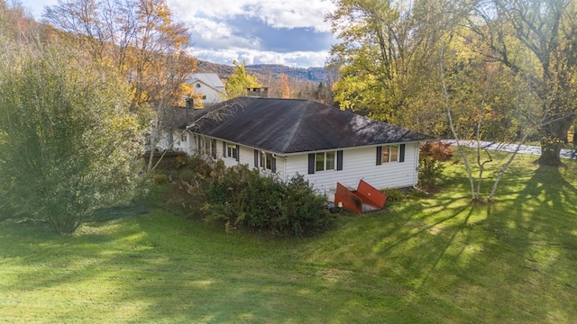 rear view of house with a yard