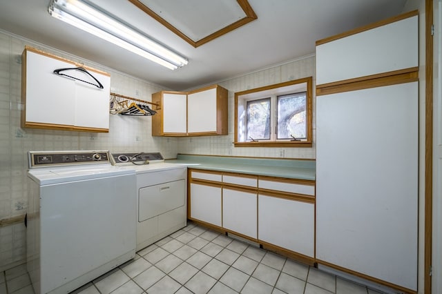 laundry room with cabinets, independent washer and dryer, and light tile patterned floors