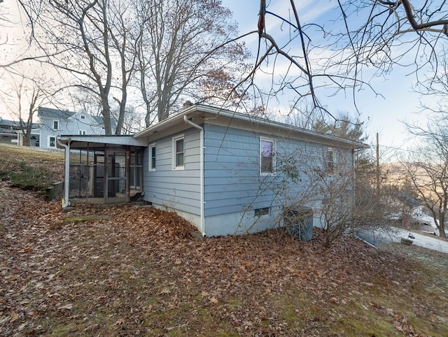 view of side of home featuring a sunroom