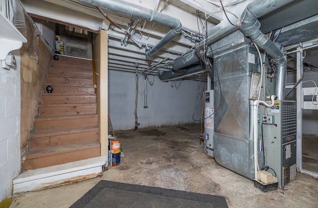 basement featuring heating unit and water heater