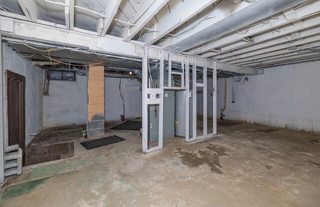 unfinished basement featuring water heater
