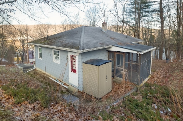 view of outdoor structure featuring a sunroom