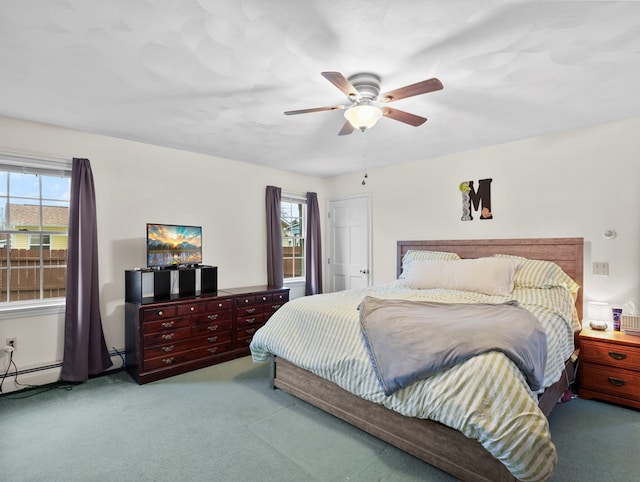 bedroom with multiple windows, ceiling fan, and light colored carpet