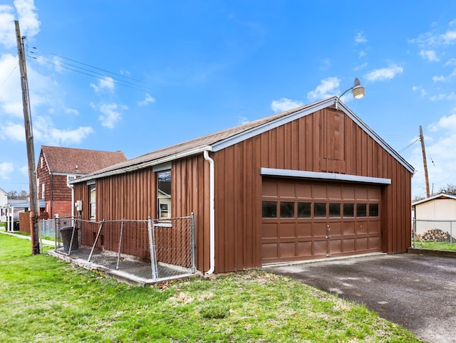 detached garage featuring fence