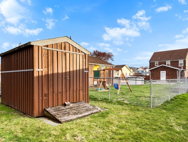 view of shed featuring a fenced backyard and a playground