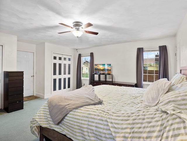 bedroom with baseboards, multiple windows, carpet, and a ceiling fan