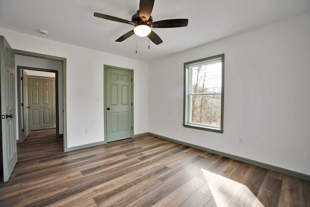 unfurnished bedroom with dark wood-type flooring and ceiling fan