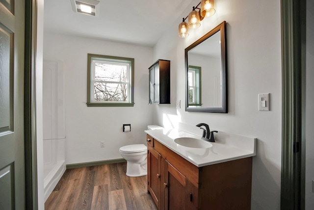 bathroom with vanity, hardwood / wood-style flooring, and toilet