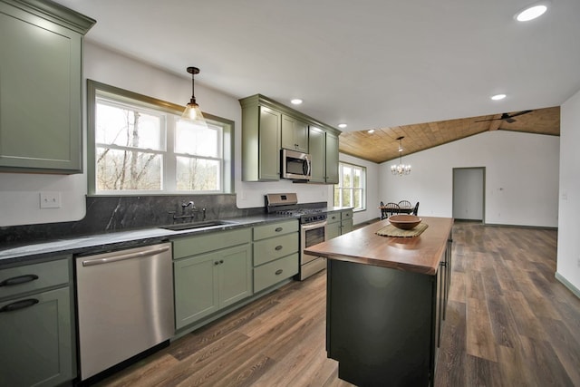 kitchen featuring wood counters, sink, stainless steel appliances, and hanging light fixtures