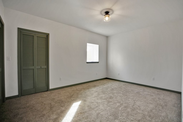 unfurnished bedroom with carpet and a closet