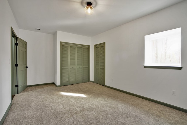 unfurnished bedroom with light colored carpet