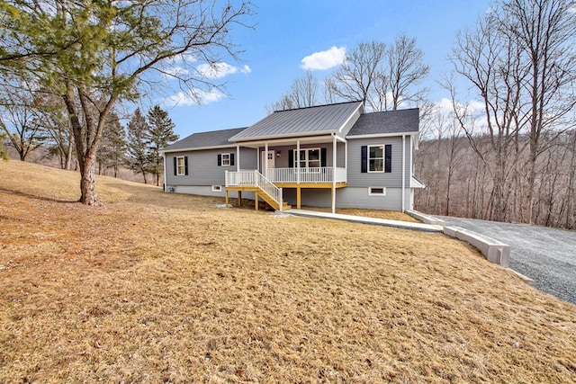 view of front facade with a front yard and a porch