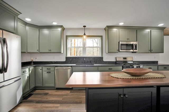 kitchen featuring sink, green cabinetry, and appliances with stainless steel finishes