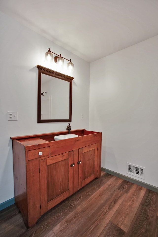 bathroom featuring vanity and hardwood / wood-style floors